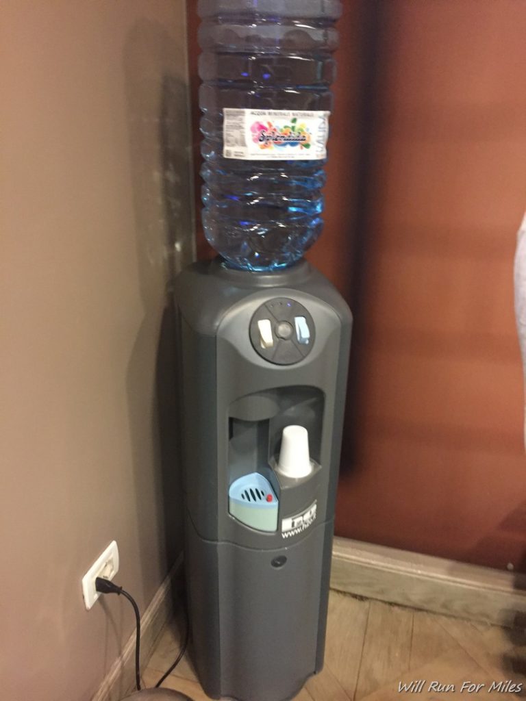a water dispenser with a water bottle on top