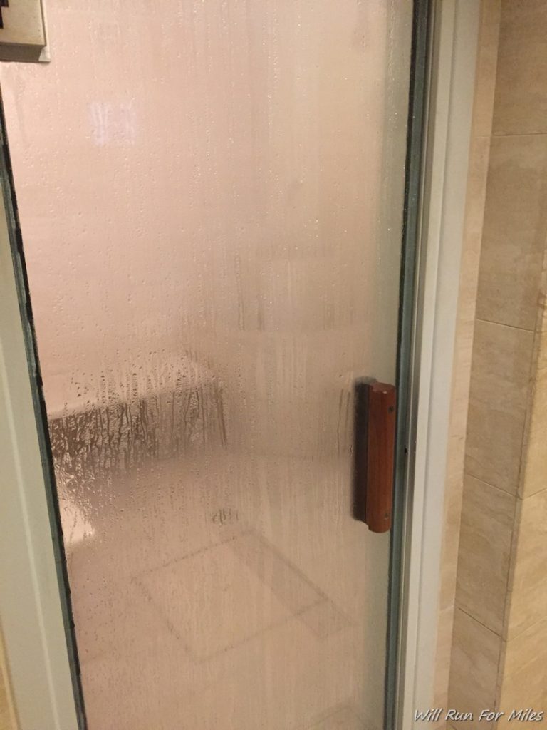 a glass door with a wood handle