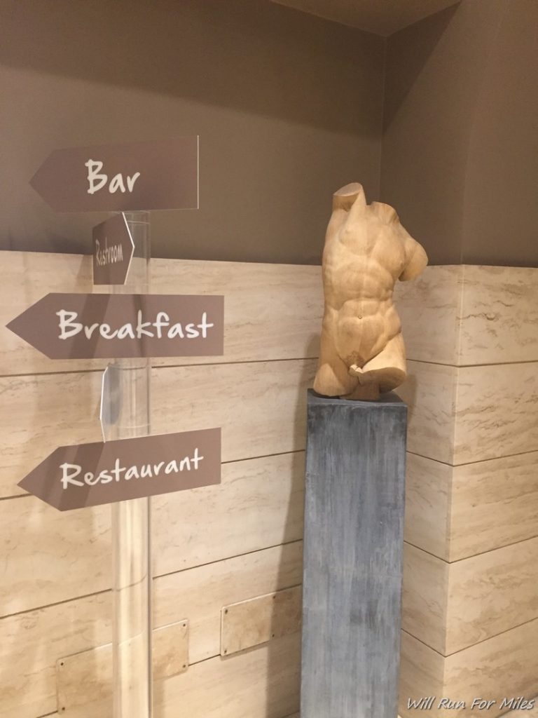 a wooden statue of a naked torso