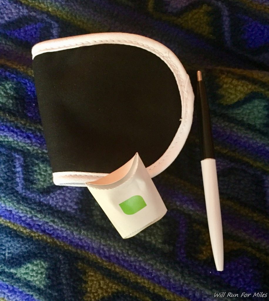 a pen and a black and white pen on a blue and green carpet