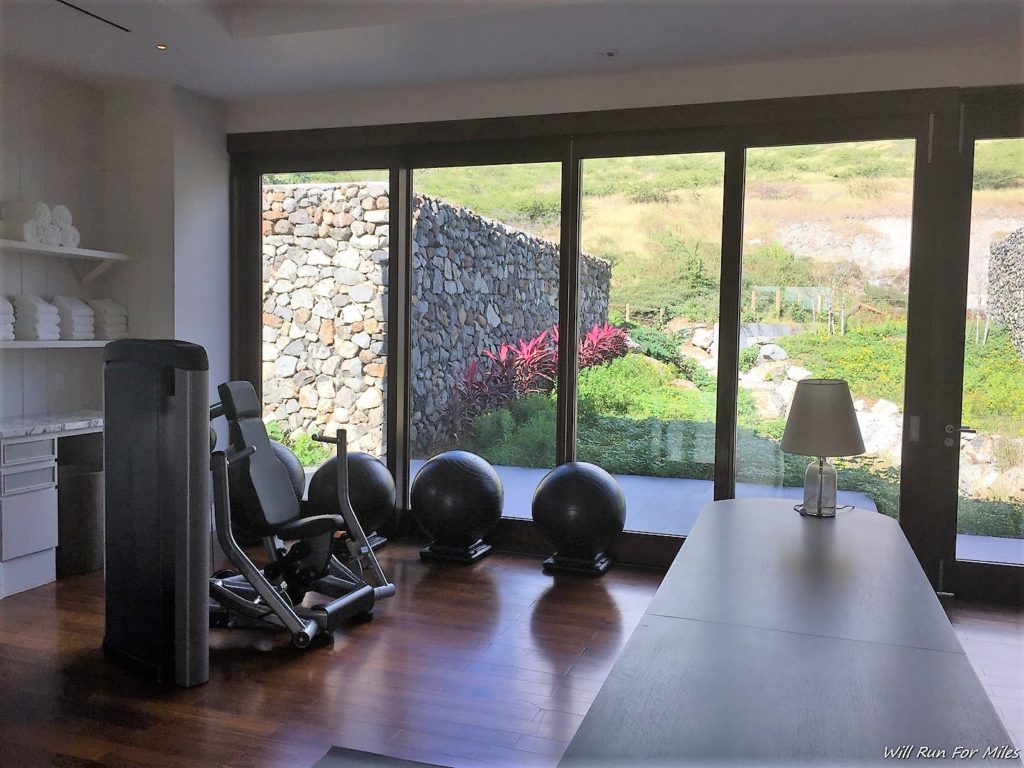 a room with exercise equipment and a table