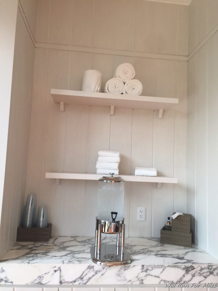 a white shelves with towels on it