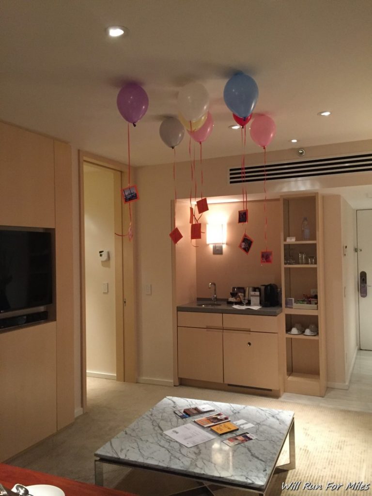 balloons in a room with pictures on the ceiling