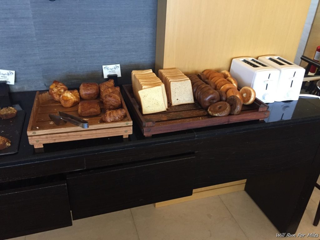 a tray of bread and bagels on a counter