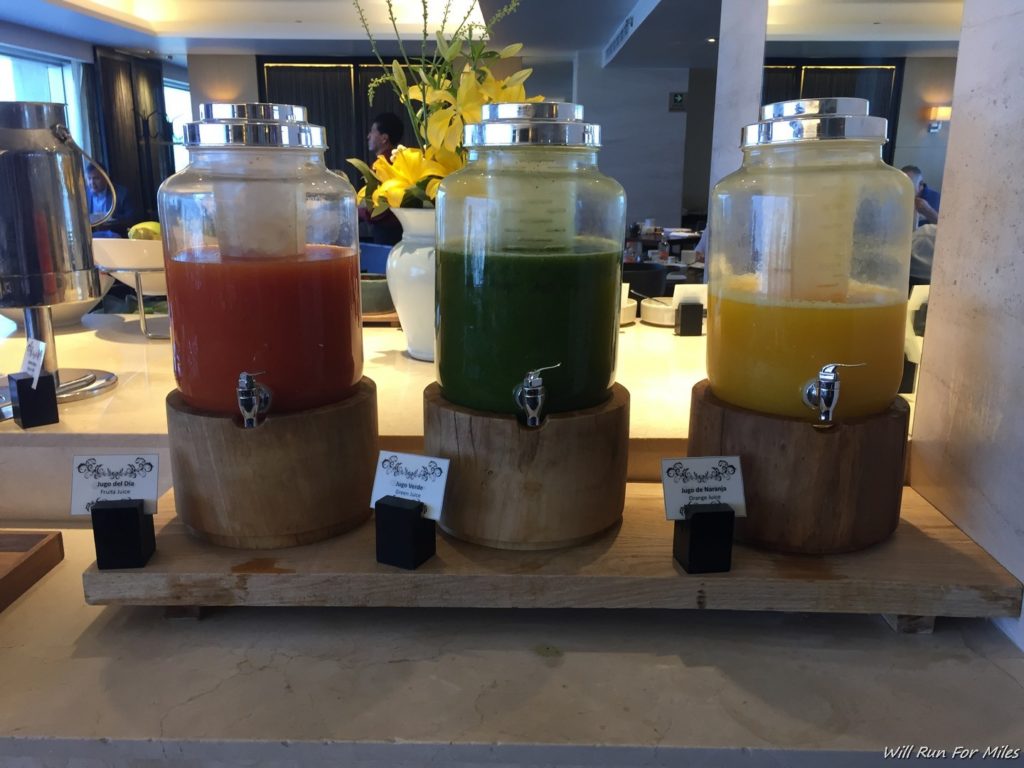 a group of juice dispensers on a table