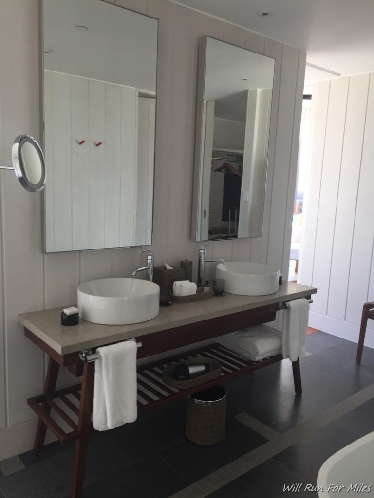 a bathroom with a sink and mirrors