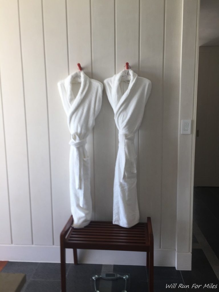 a pair of white robes on a wooden bench