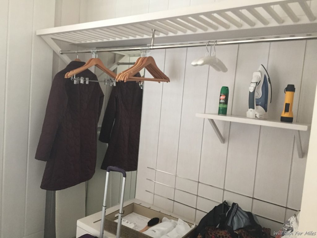 clothes swingers and a shelf in a room