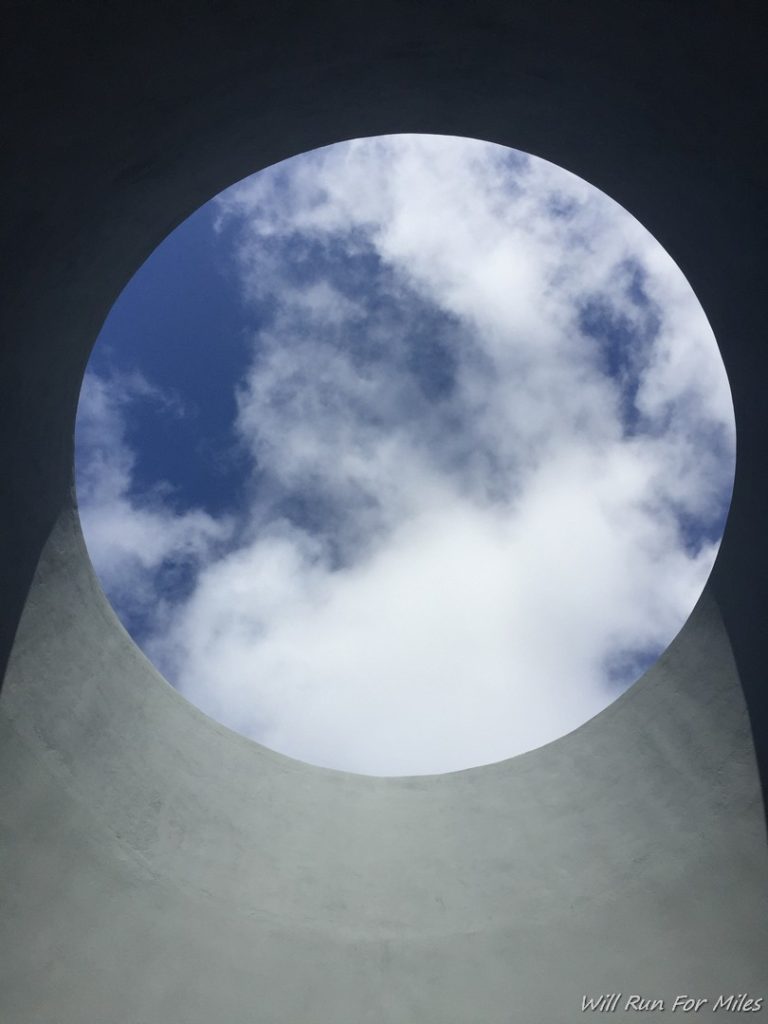 a circular skylight with clouds in the sky