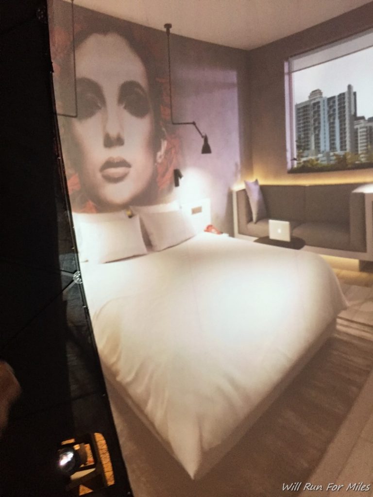 a bed with a poster on the wall