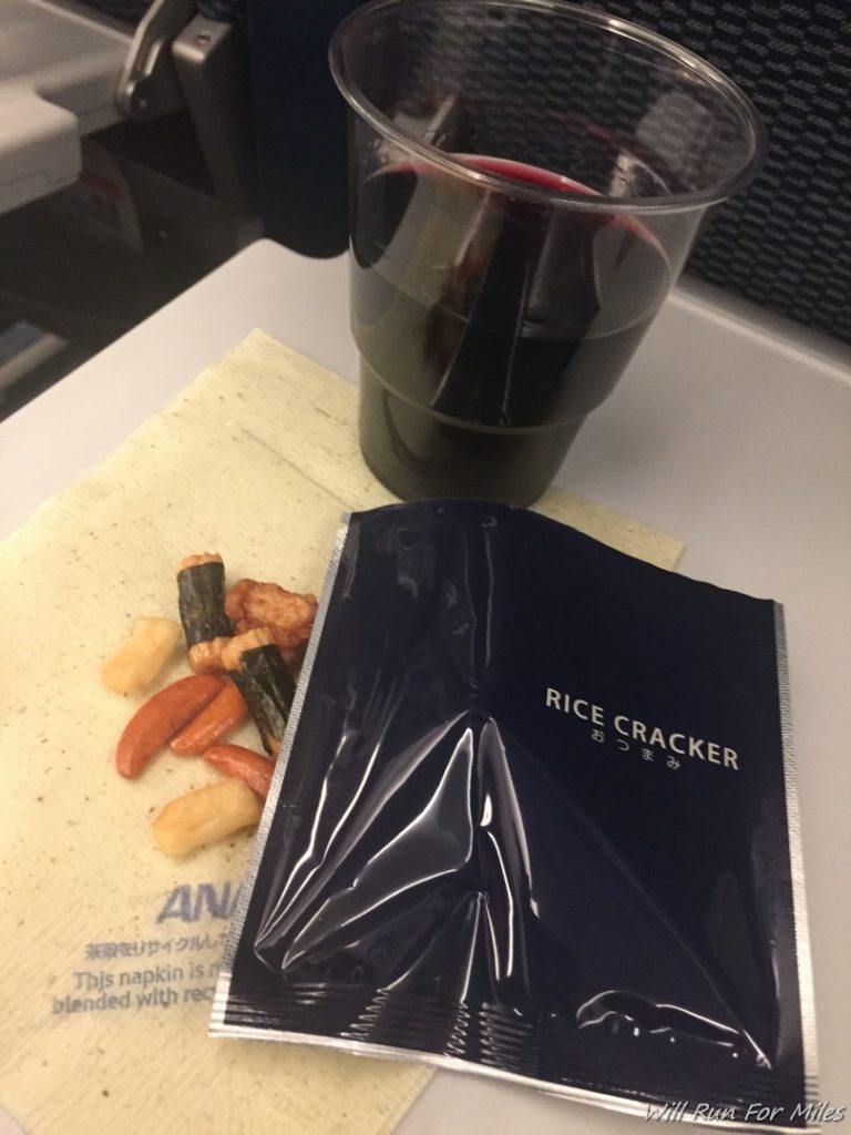 a glass of wine next to a snack