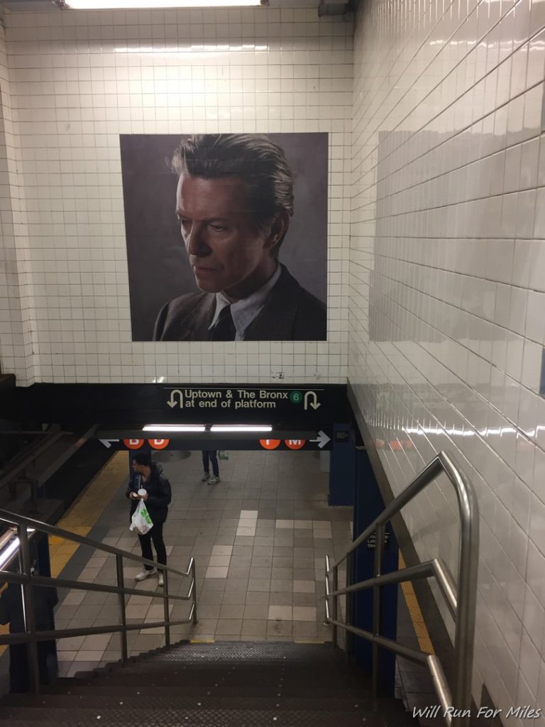 a poster on the wall of a subway station