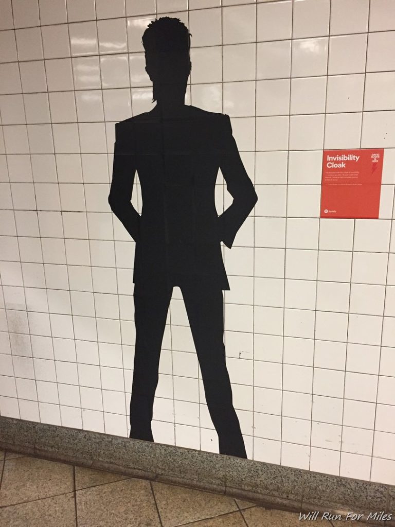 a silhouette of a man on a tile wall