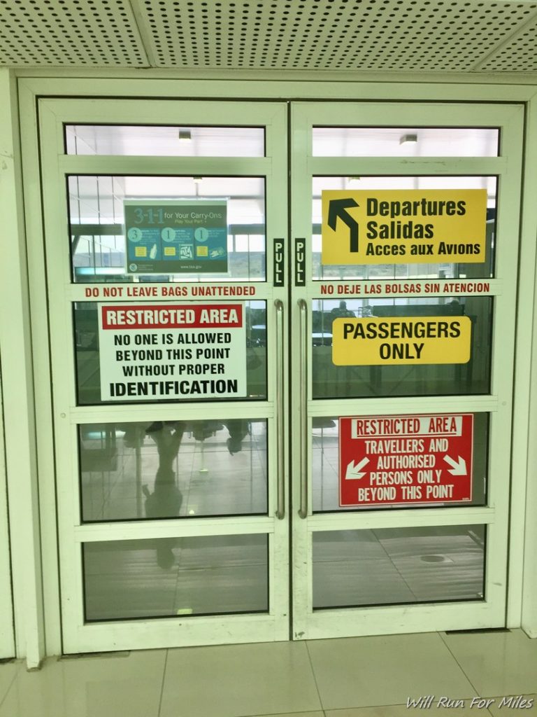a double glass doors with signs