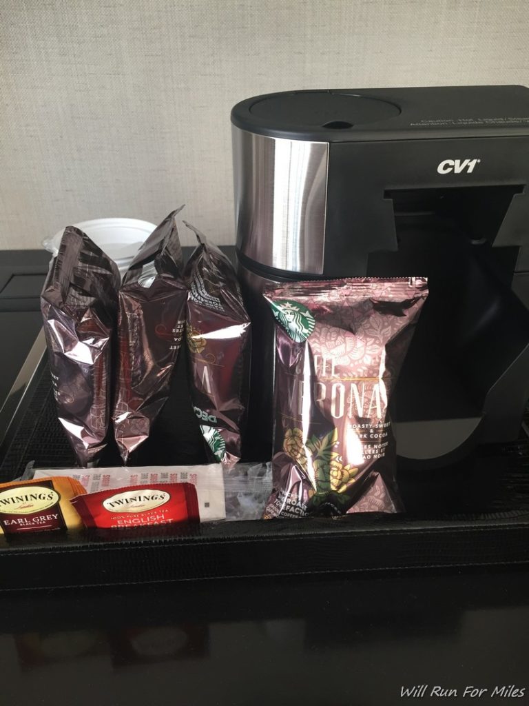 a coffee machine with bags of coffee and snacks
