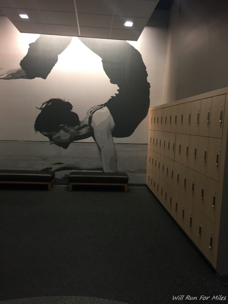 a mural of a woman doing yoga in a locker room