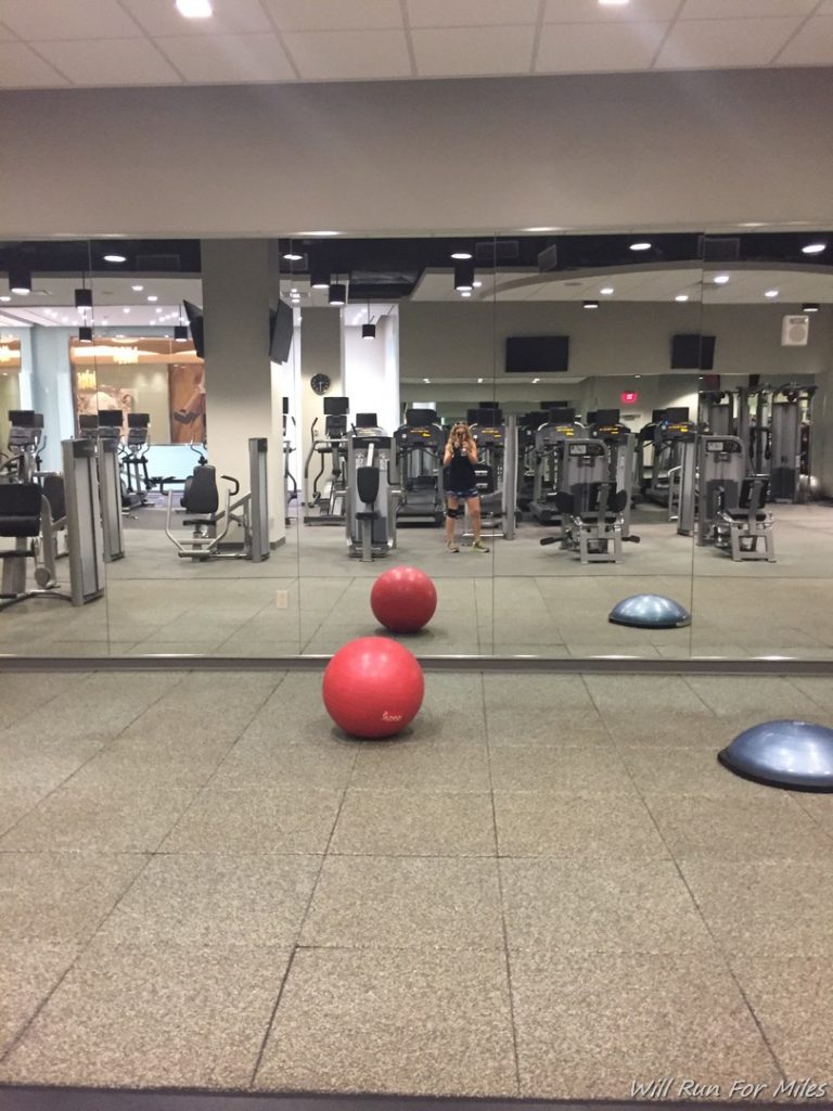 a mirror of a gym with exercise equipment