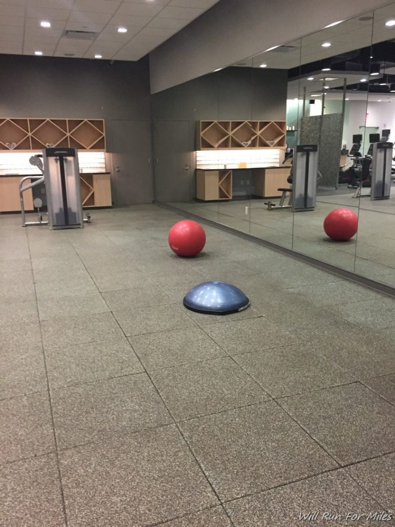 a gym with red balls on the floor