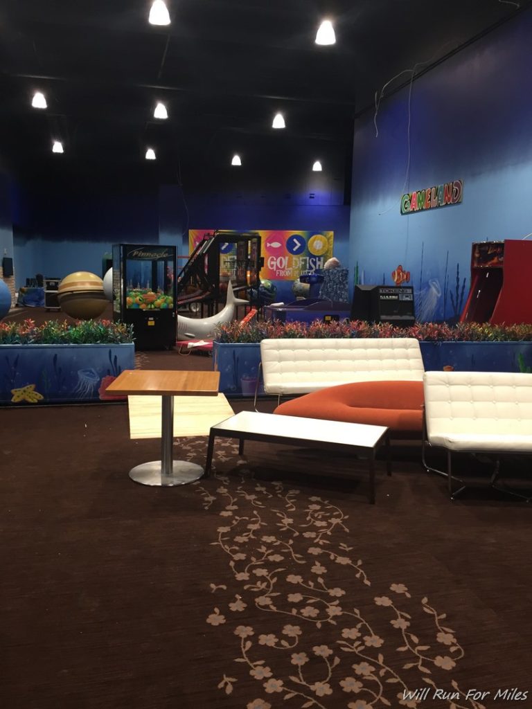 a room with a play area and a couch and a slide