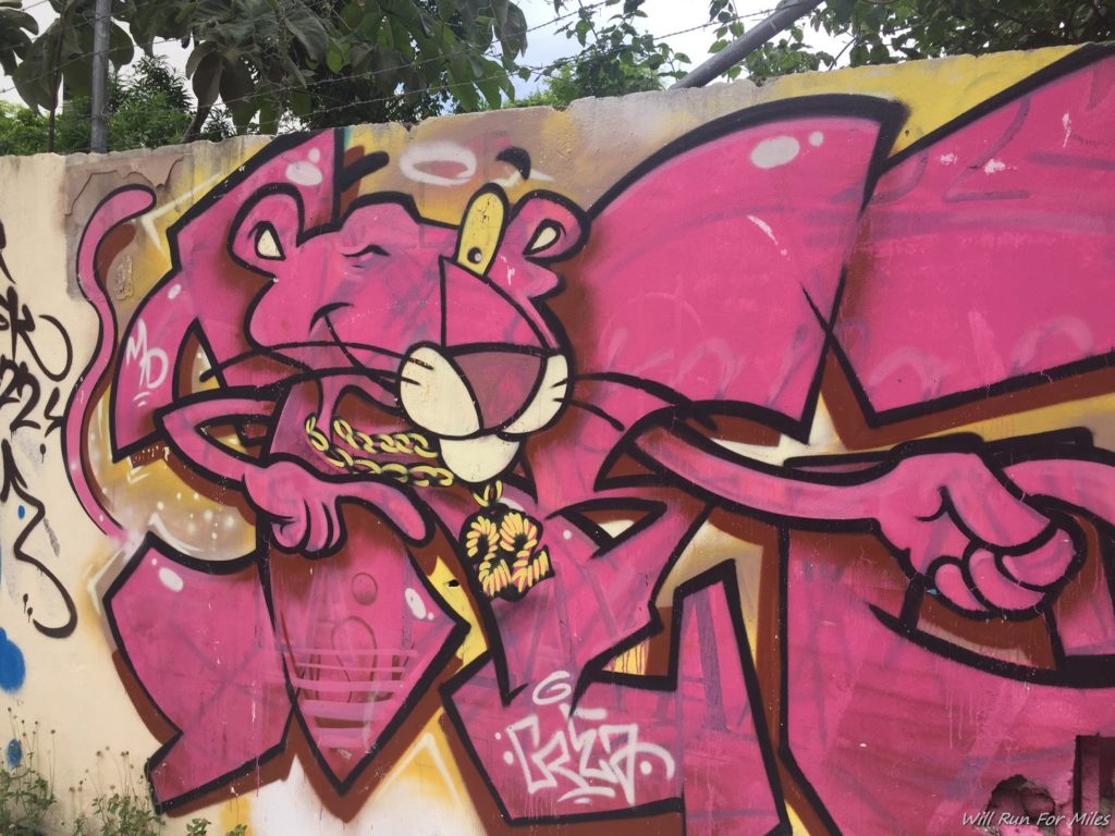 a pink panther graffiti on a wall