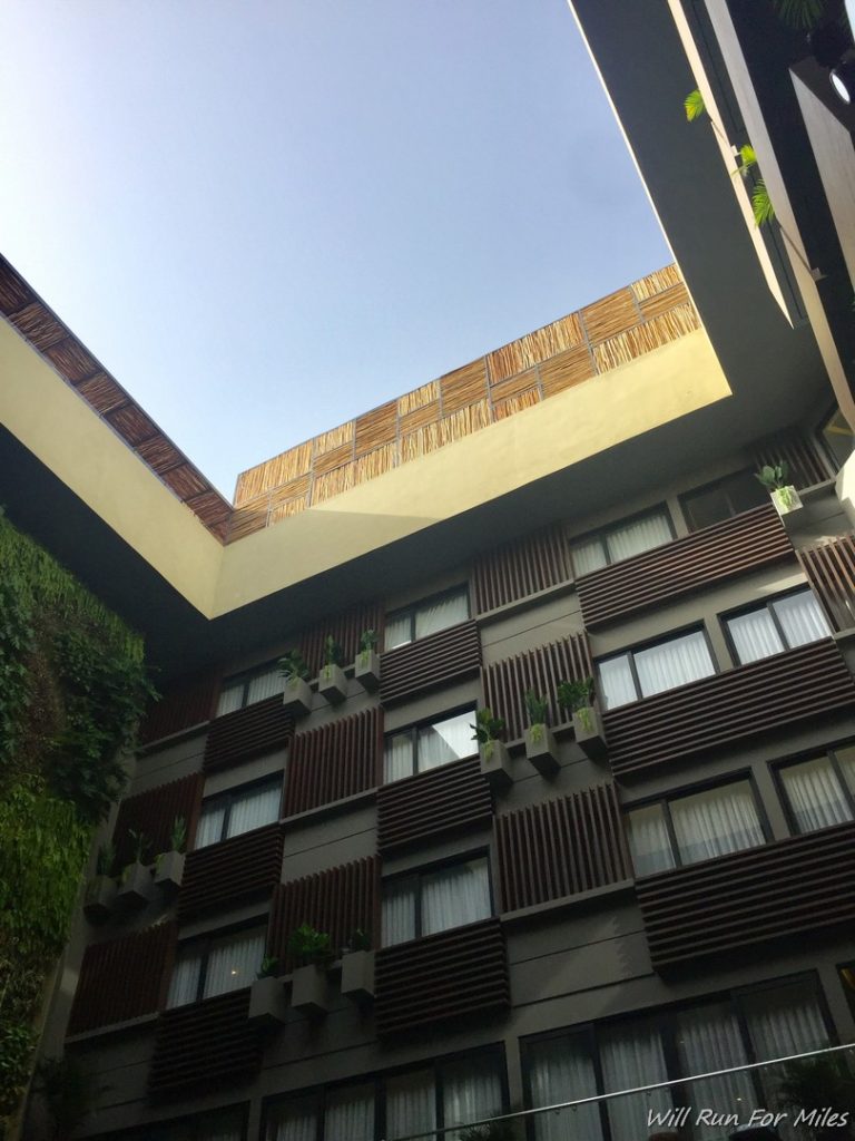 a building with a roof and plants