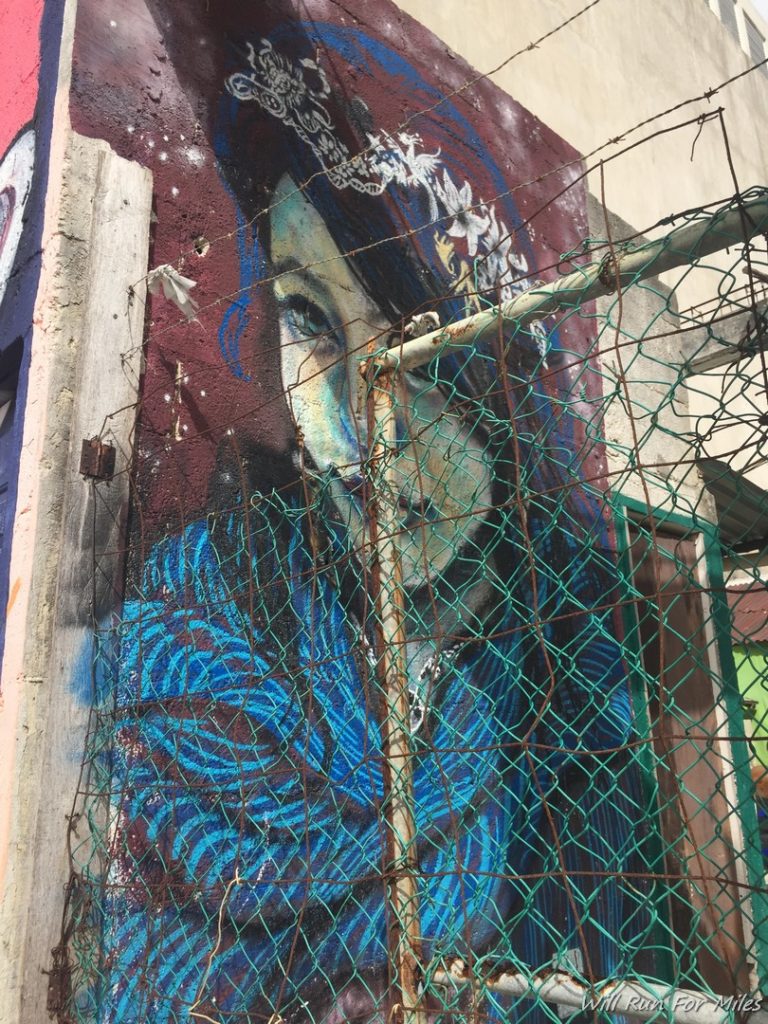 a mural of a woman in a blue scarf