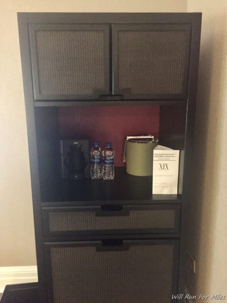 a shelf with a book and bottles on it