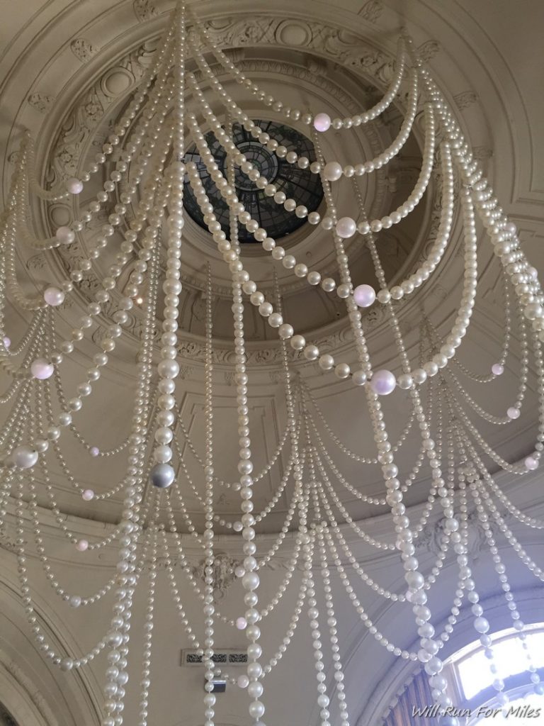 a chandelier with pearls from the ceiling