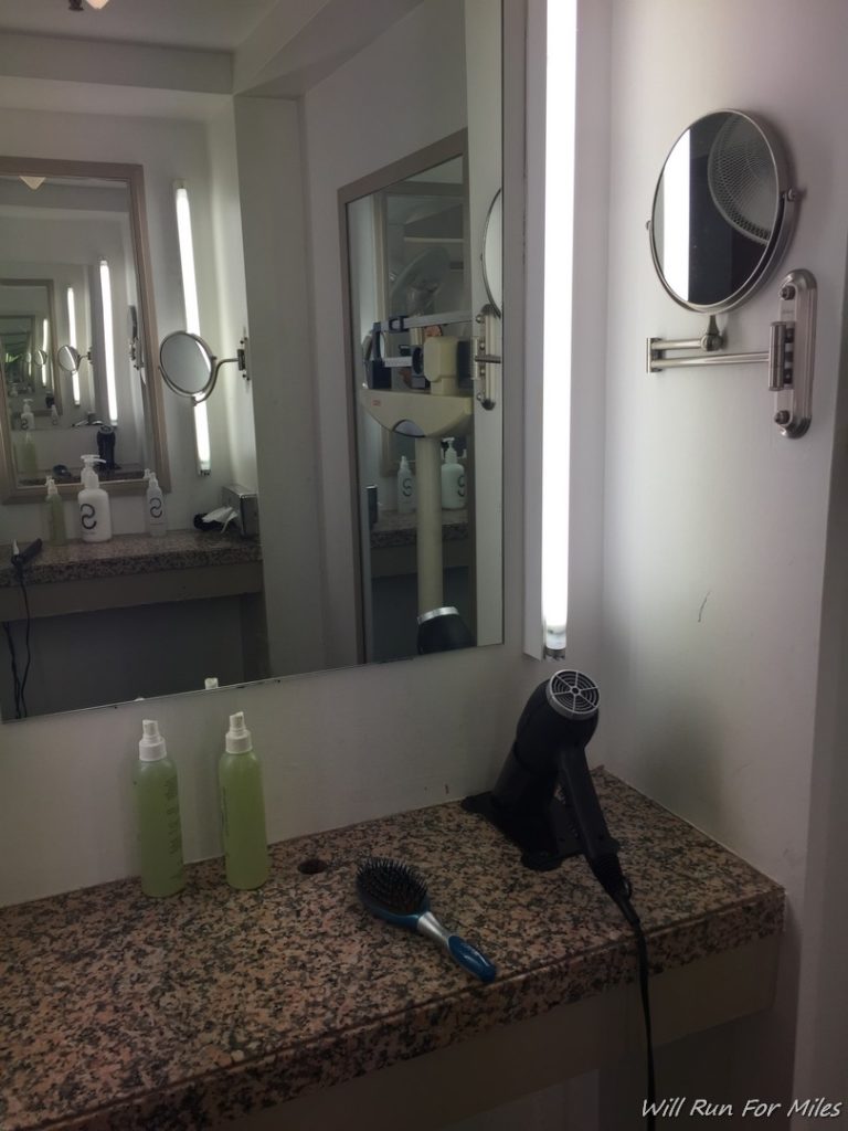 a mirror and a blow dryer on a counter