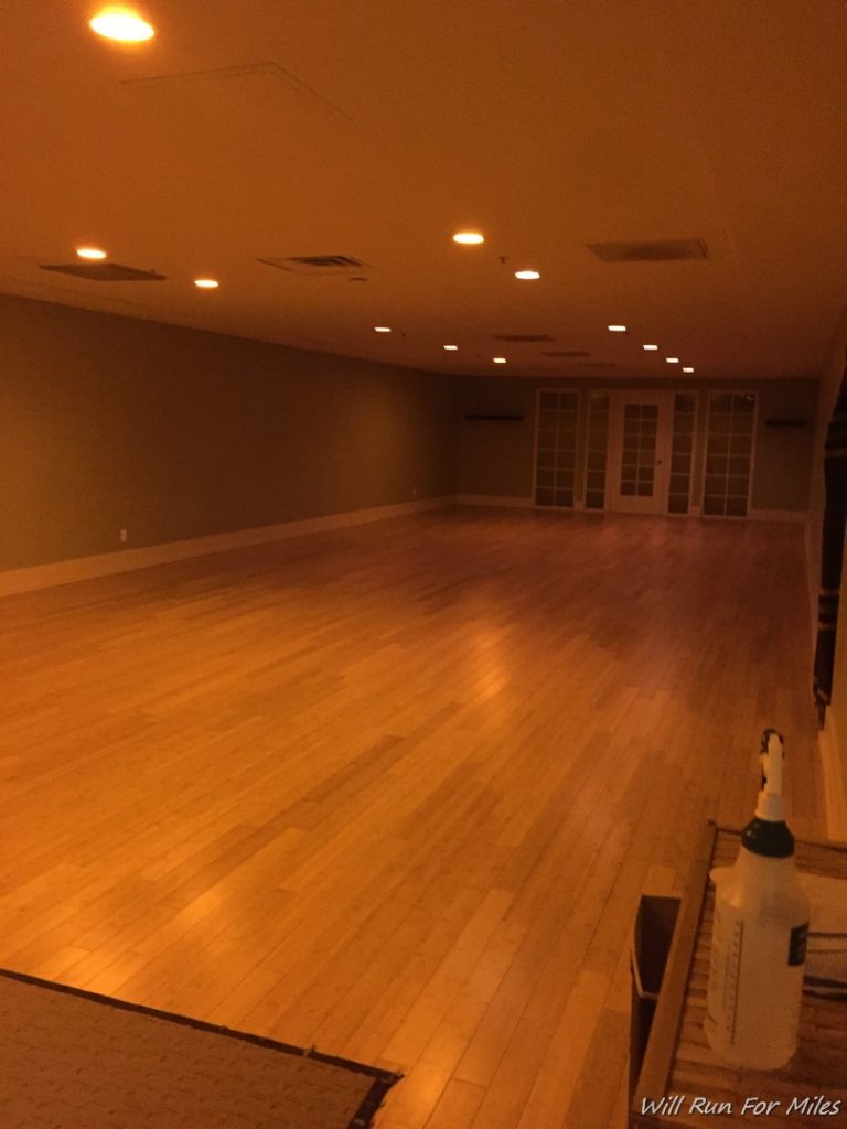 a room with a wood floor and a white spray bottle