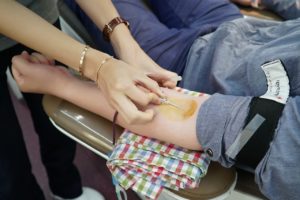 a person getting blood from a blood sample