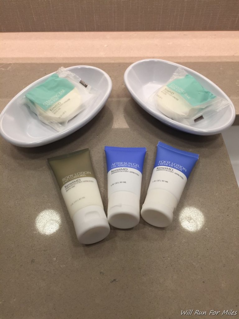 a group of toiletries and a couple of small bowls on a counter