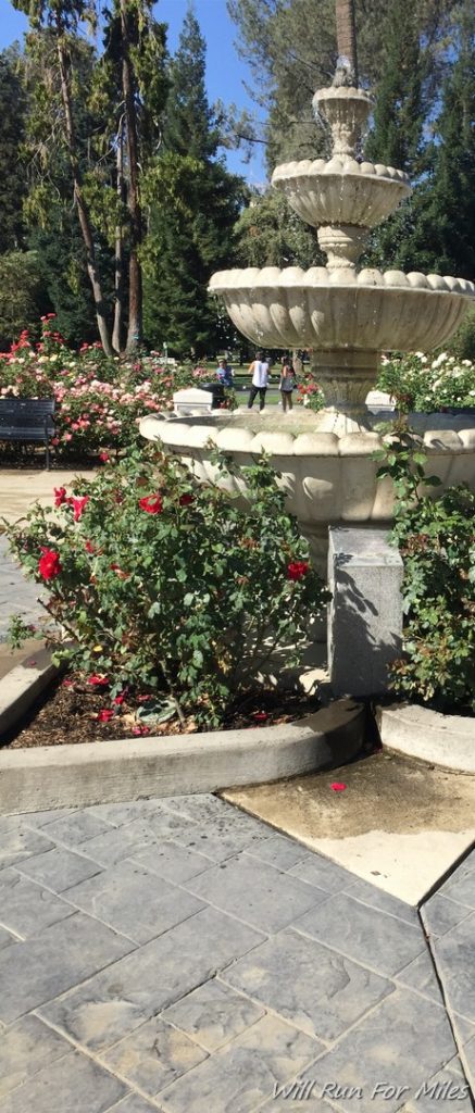 a fountain with a group of people walking around