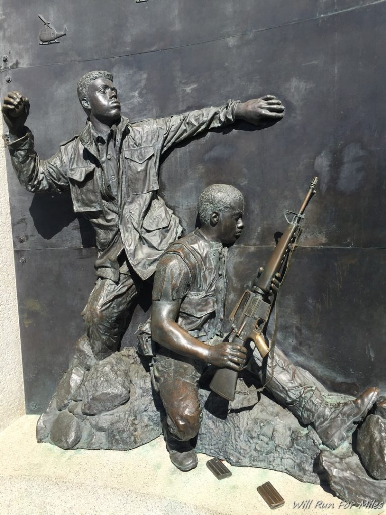 a statue of a man holding a gun