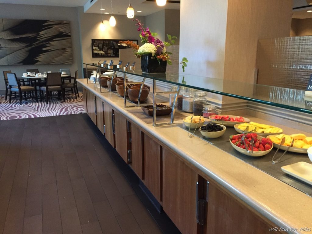 a buffet with bowls of fruit