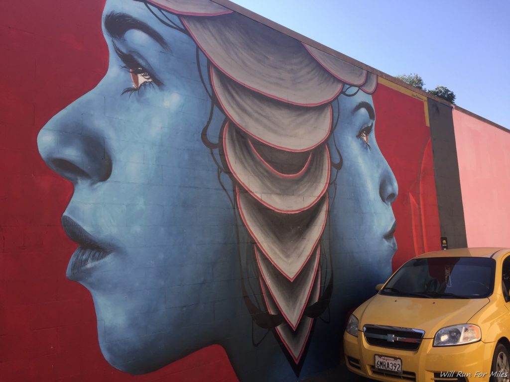 a wall with a painting of a woman's face