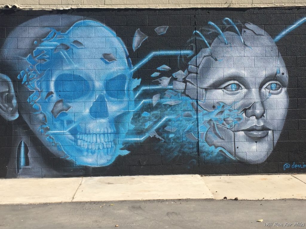a wall with a skull and a human face painted on it