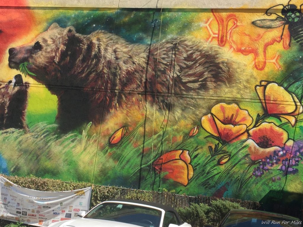 a mural of a bear and flowers