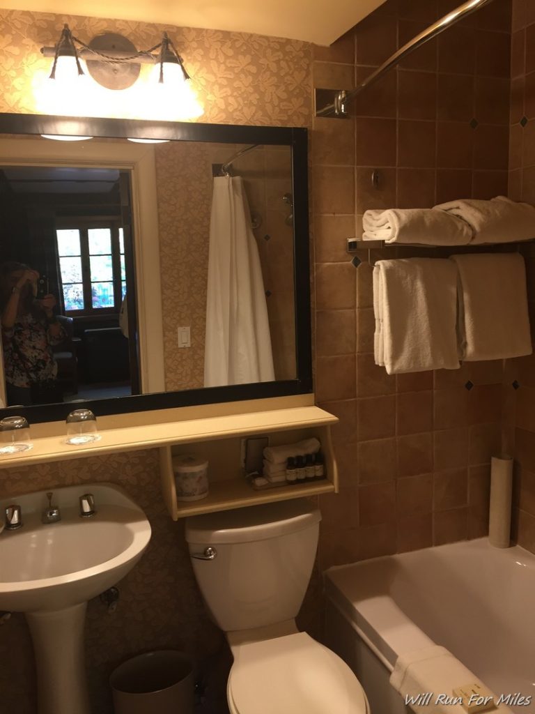 a bathroom with a mirror and a bathtub