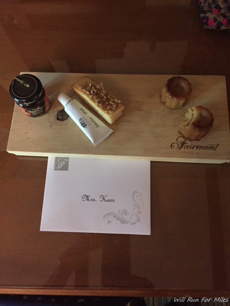 a wooden board with food and a piece of paper