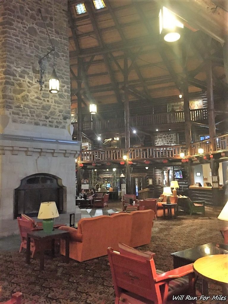 a large room with a stone fireplace and couches