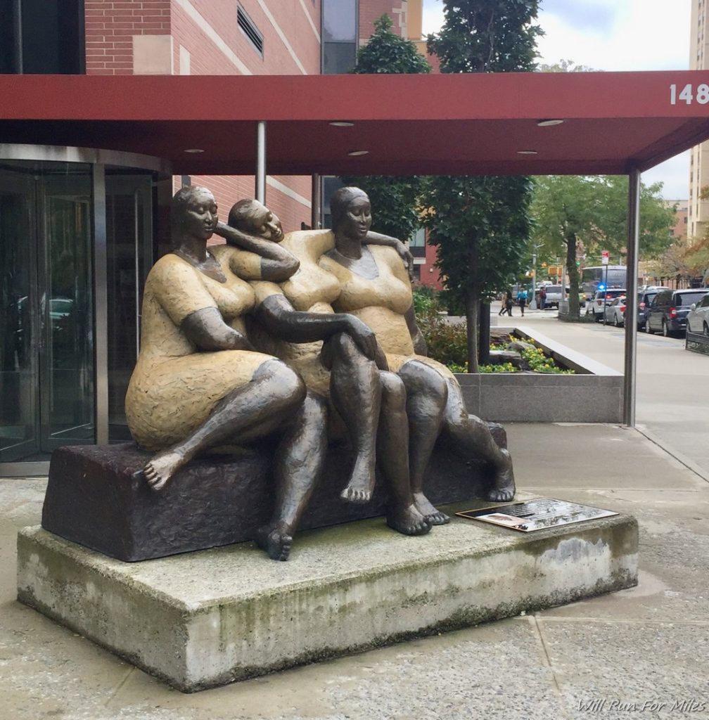 a statue of women sitting on a bench