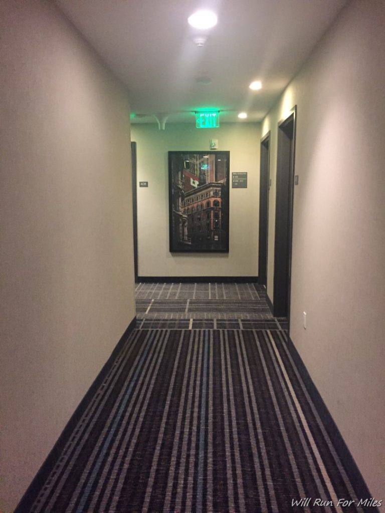 a hallway with a picture on the wall