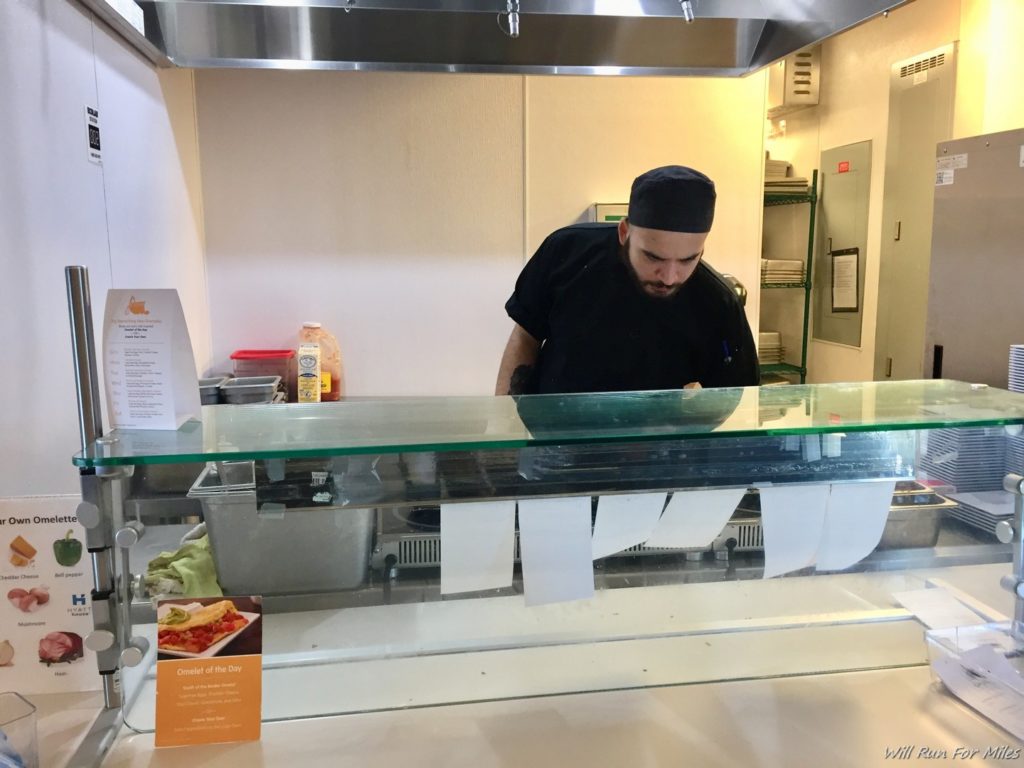 a man standing behind a glass counter