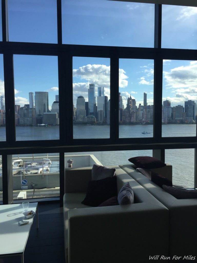 a room with a view of a city and water