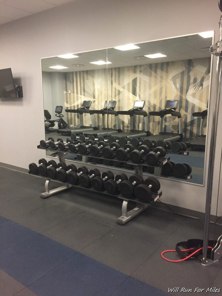 a mirror with a rack of weights