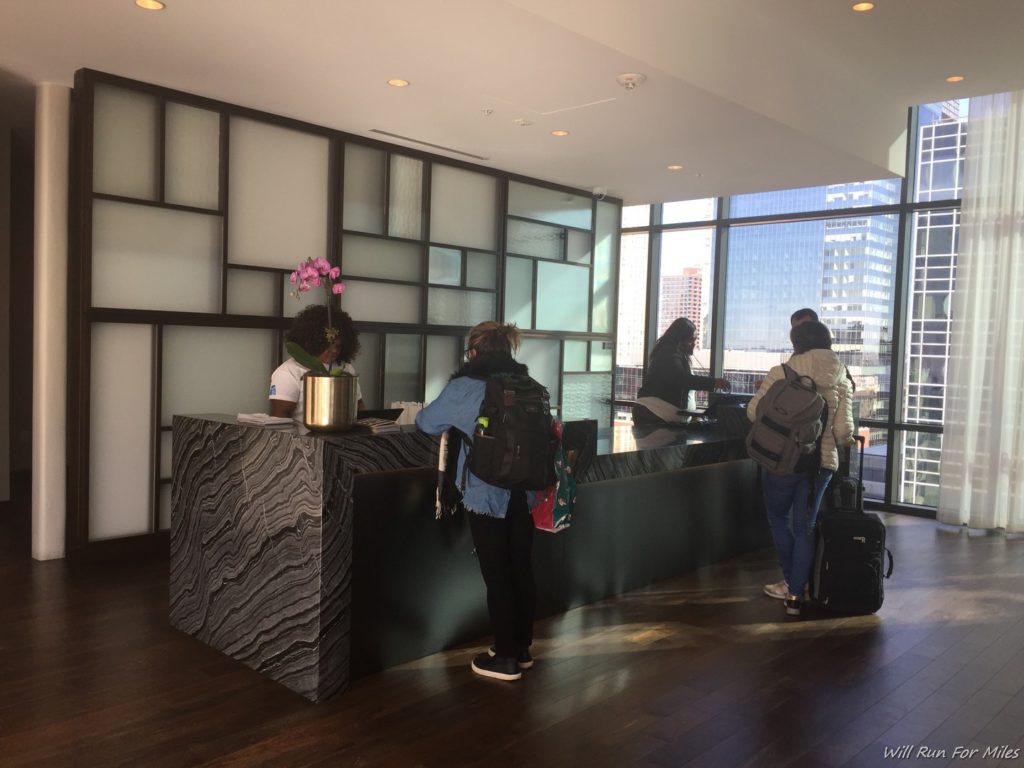 people standing at a counter in a hotel