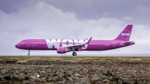a large pink airplane on a runway