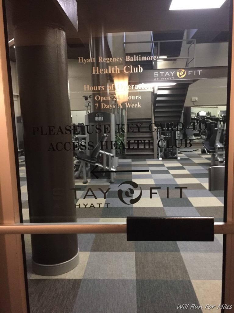 a glass door with a gym and exercise equipment