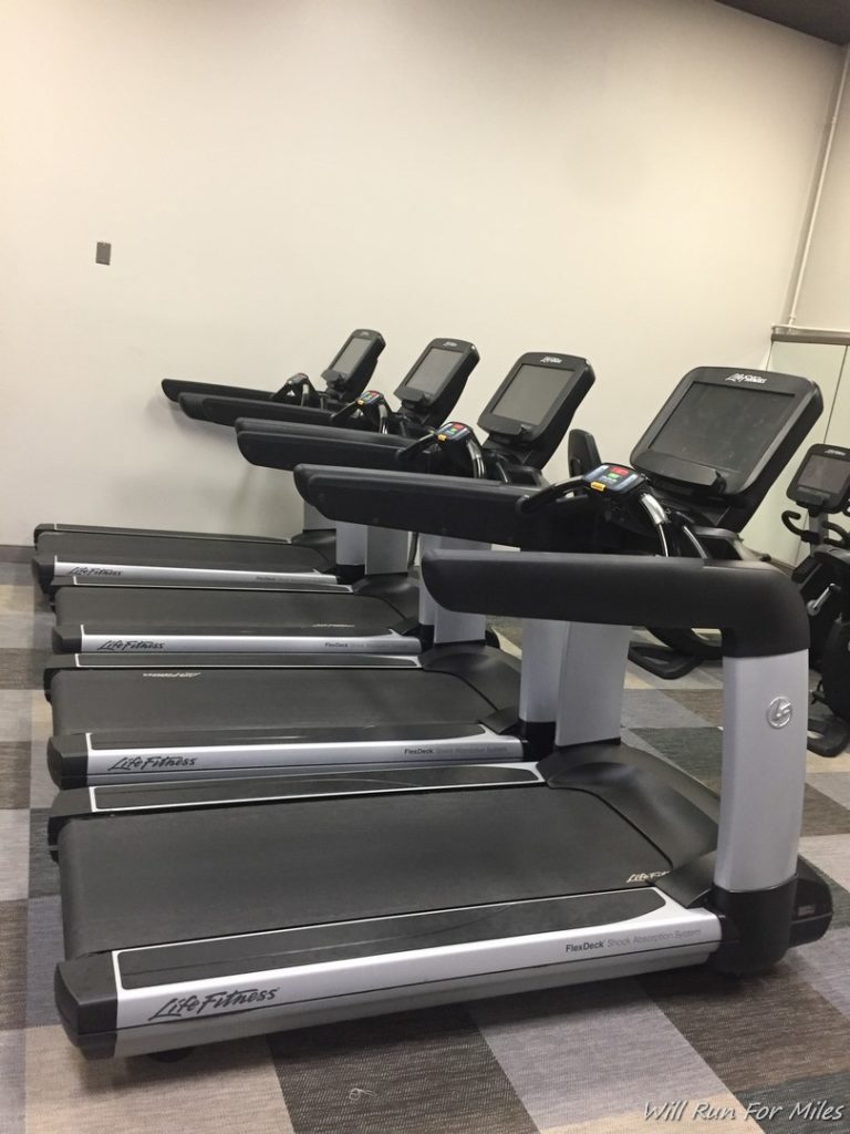 a row of treadmills in a room